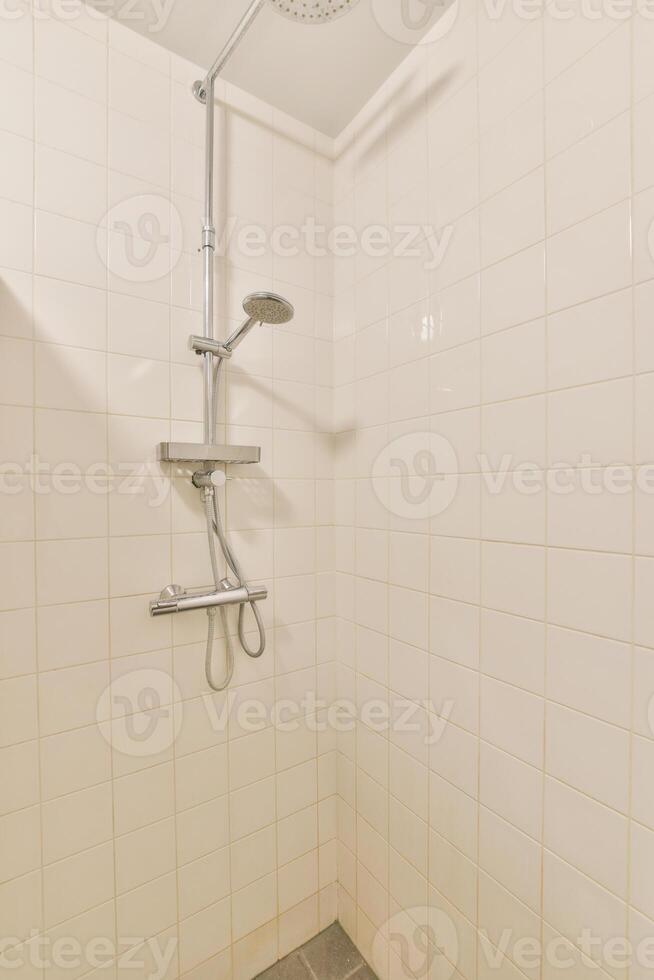 A shower with a shower head photo