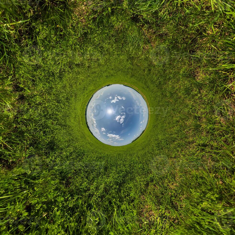 blue hole sphere or globe little planet inside sand or dry ground frame background with tractor tracks photo