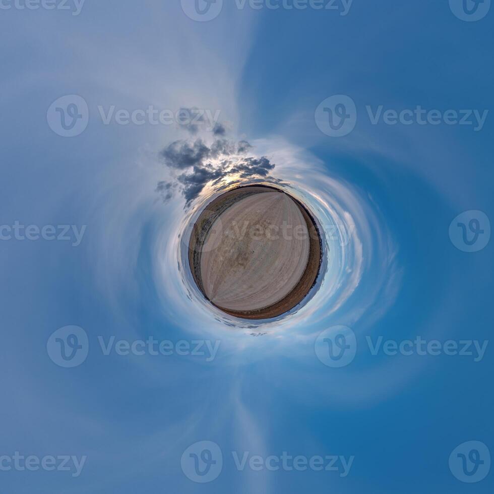 simple little tiny planet without buildings in blue sky with beautiful clouds. Transformation of spherical panorama 360 degrees. Spherical abstract aerial view. Curvature of space. photo