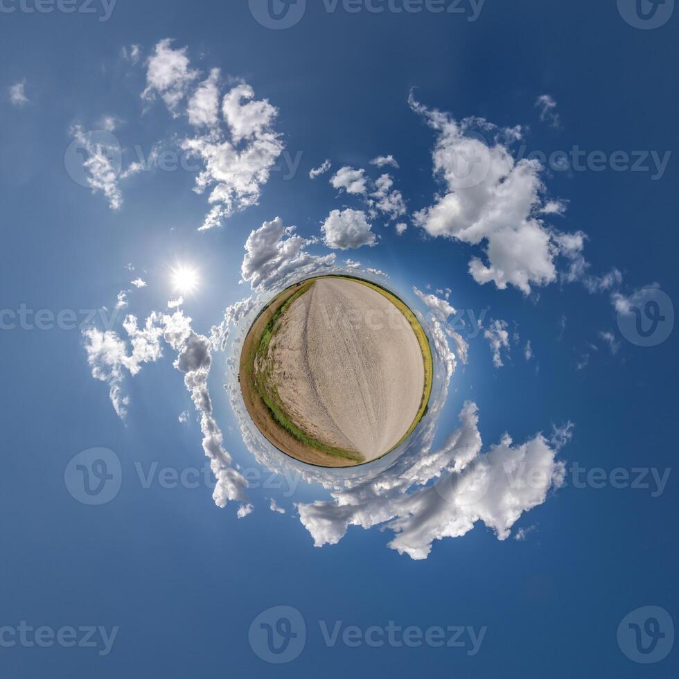 simple little tiny planet without buildings in blue sky with beautiful clouds. Transformation of spherical panorama 360 degrees. Spherical abstract aerial view. Curvature of space. photo