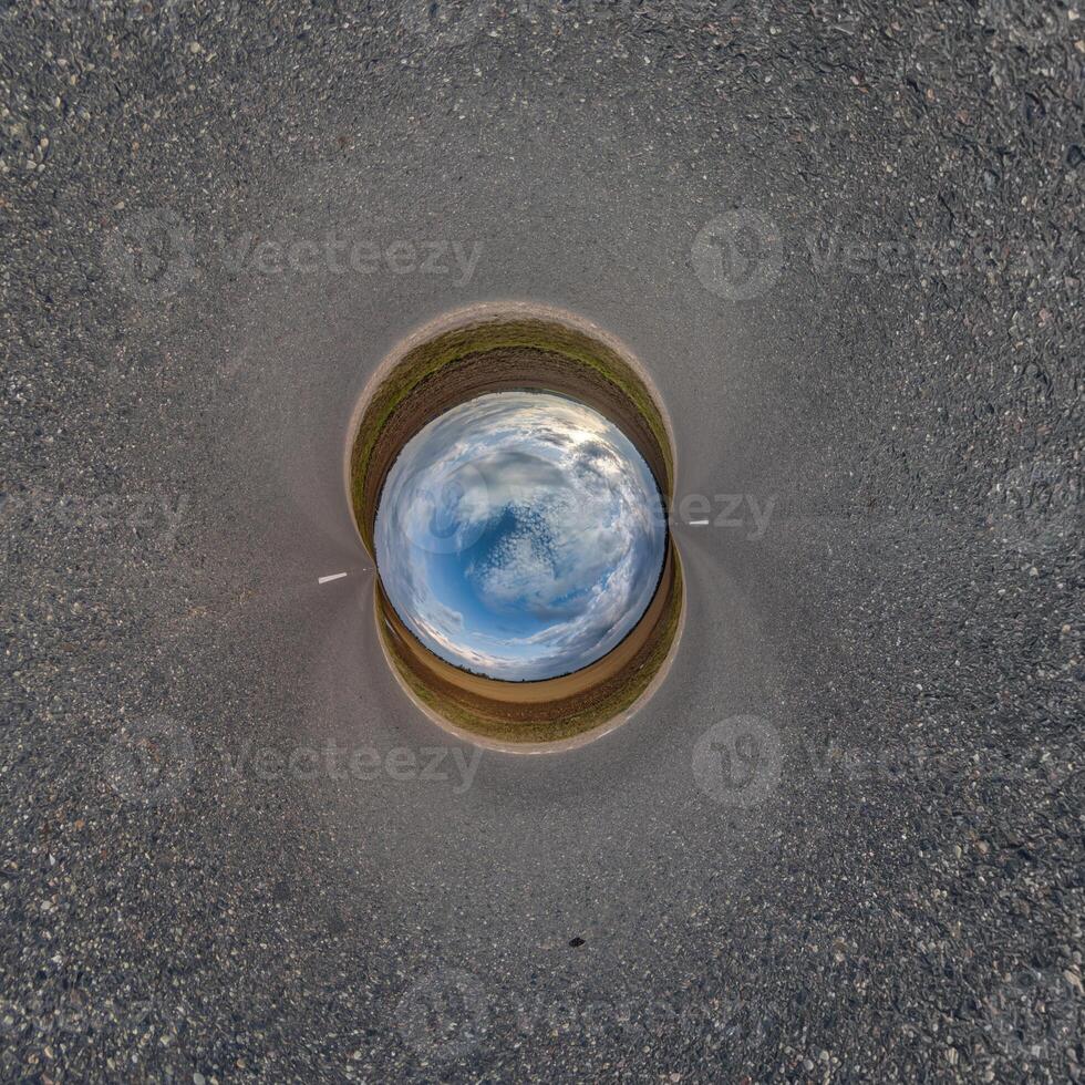 blue hole sphere or globe little planet inside sand or dry ground frame background with tractor tracks photo