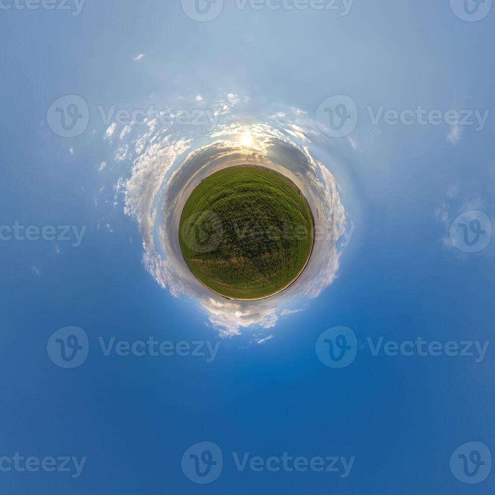simple little tiny planet without buildings in blue sky with beautiful clouds. Transformation of spherical panorama 360 degrees. Spherical abstract aerial view. Curvature of space. photo