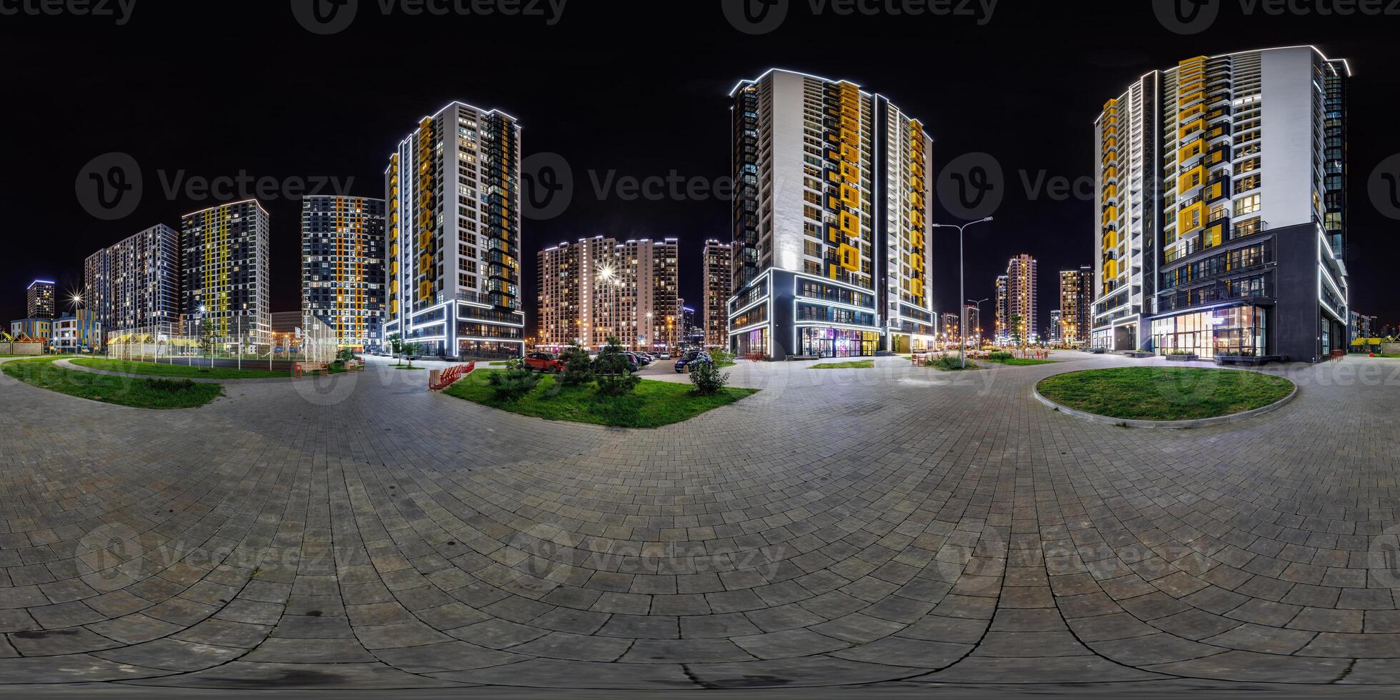 night panorama 360 near skyscraper multistory buildings with illumination of residential quarter complex in full equirectangular seamless spherical projection photo