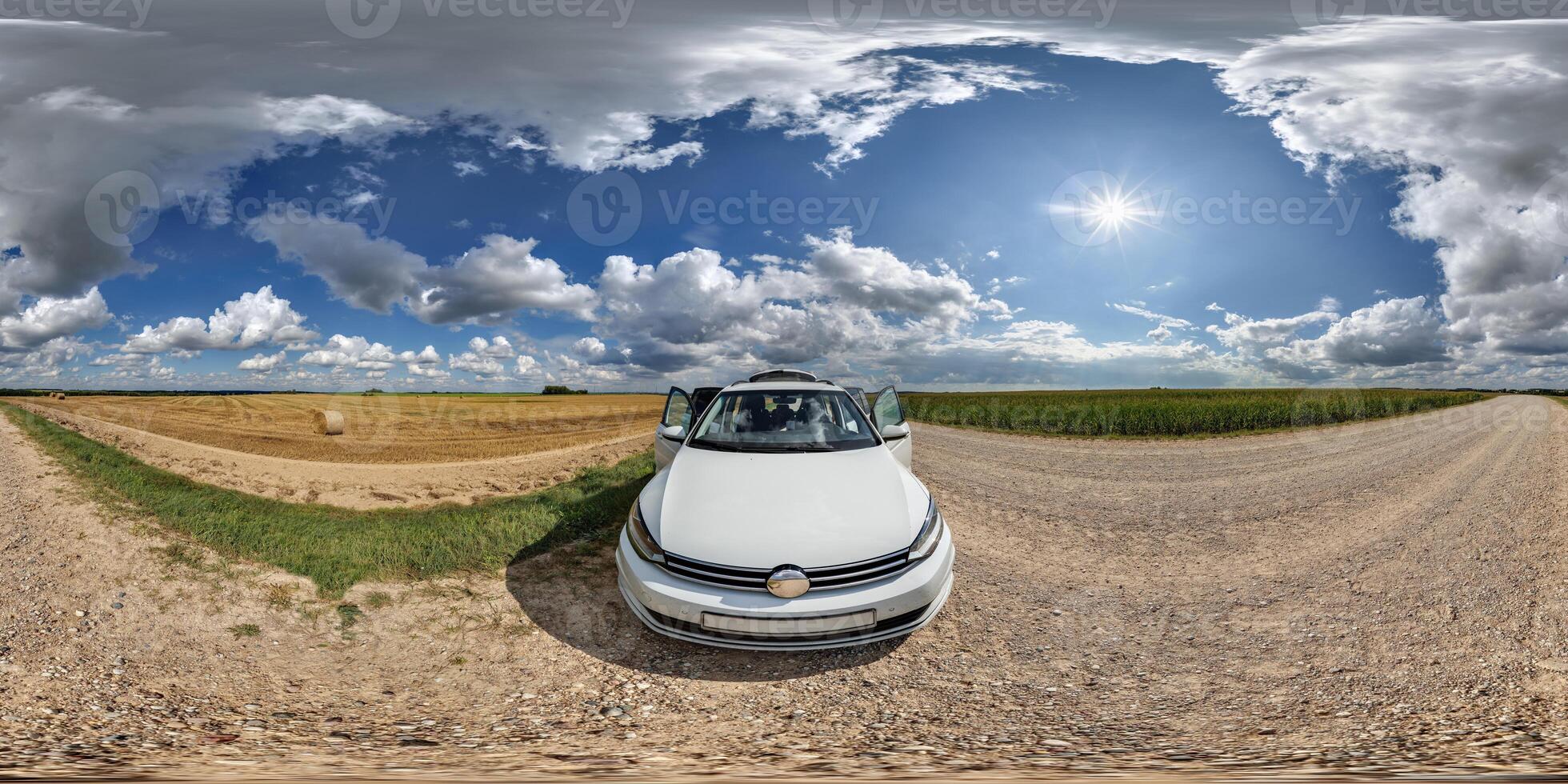 hdri 360 panorama near white car on roadside of gravel dusty road in field with blue sky and awesome clouds in equirectangular full seamless spherical projection, for VR AR content photo