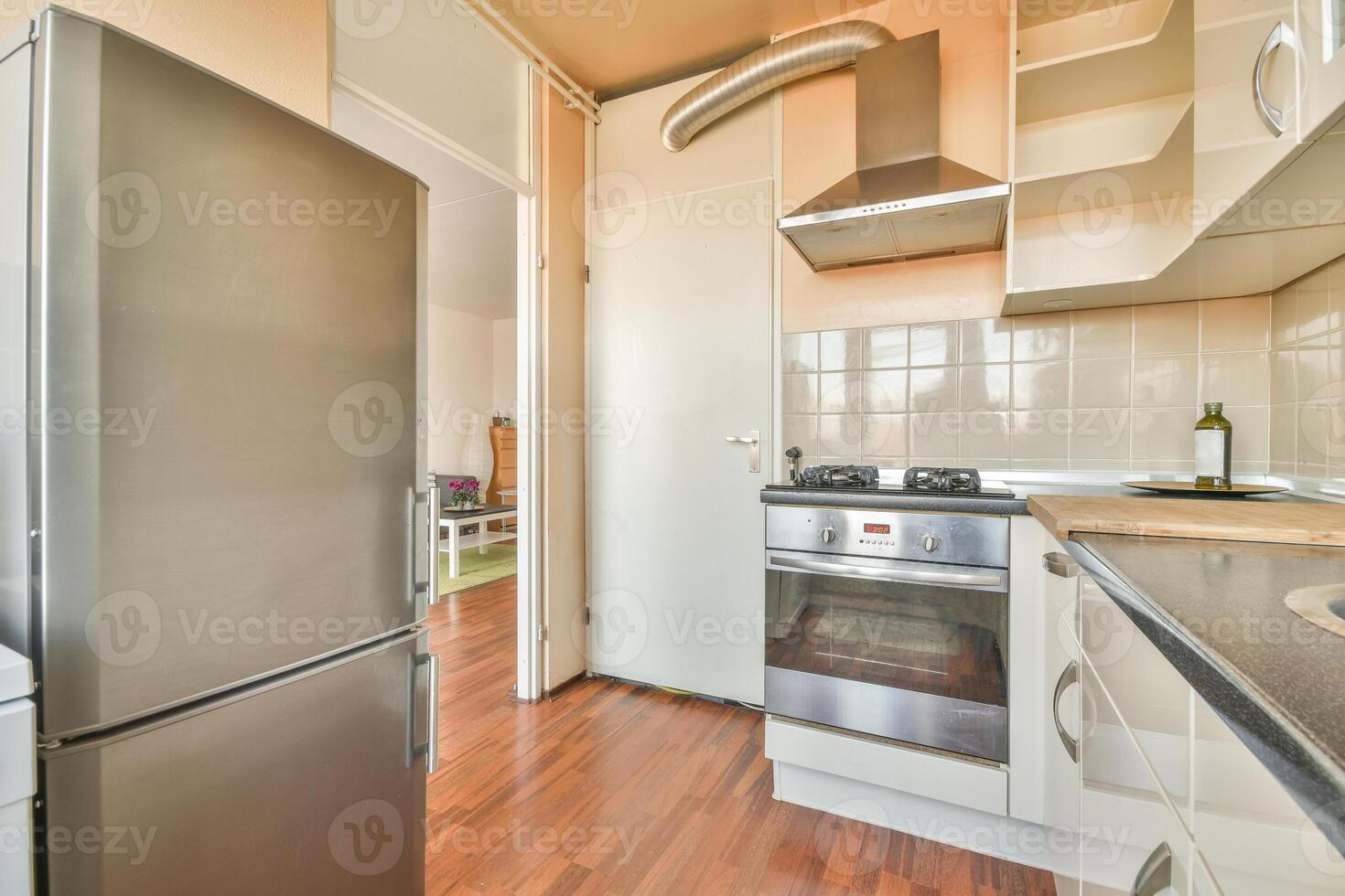 A kitchen with a refrigerator and stove photo