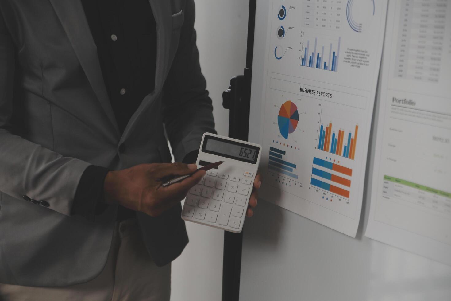 Close up of Business team analyzing income charts and graphs with modern laptop computer. Business analysis and strategy concept. photo