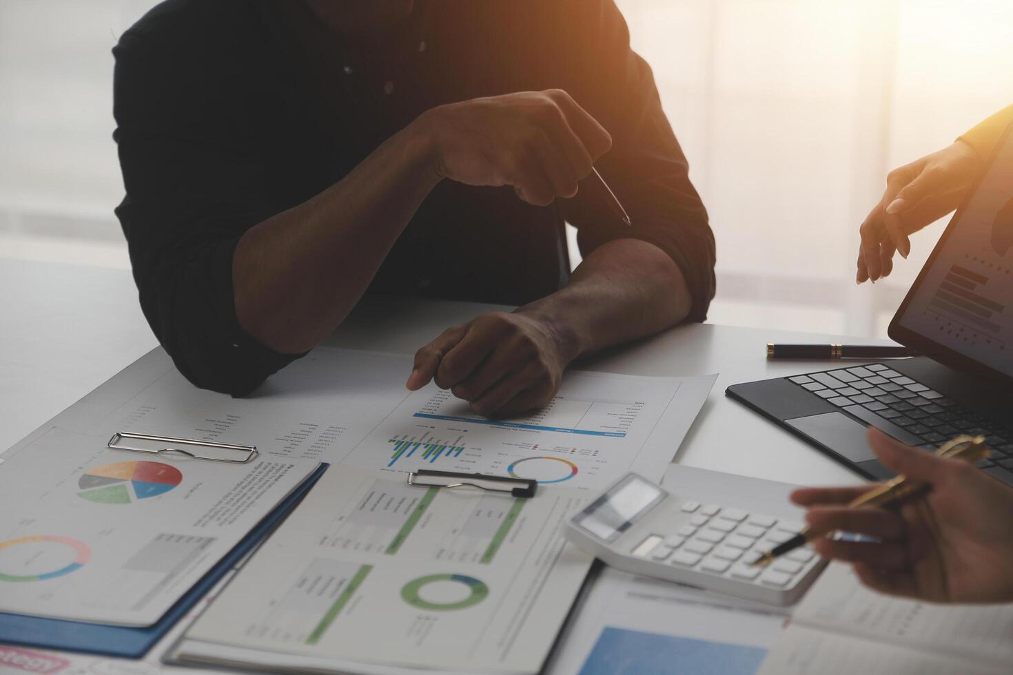 Close up of Business team analyzing income charts and graphs with modern laptop computer. Business analysis and strategy concept. photo