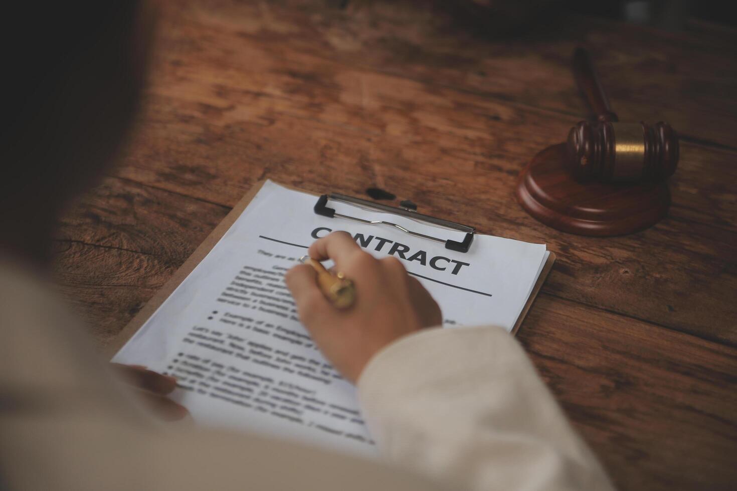 Business and lawyers discussing contract papers with brass scale on desk in office. Law, legal services, advice, justice and law concept picture with film grain effect photo