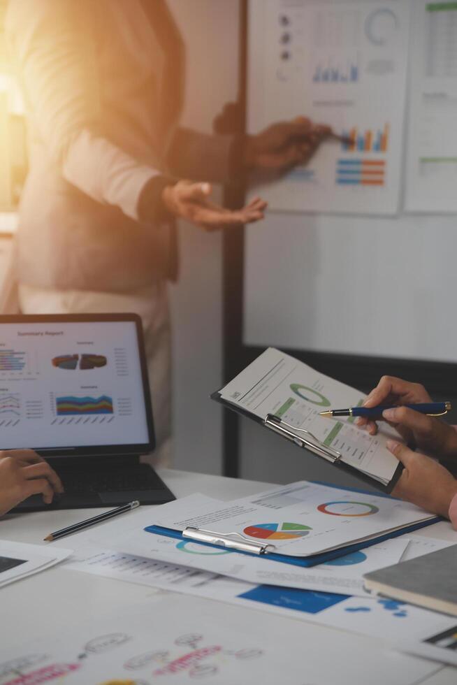 Close up of Business team analyzing income charts and graphs with modern laptop computer. Business analysis and strategy concept. photo