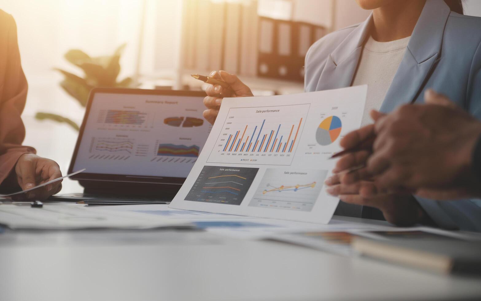 Close up of Business team analyzing income charts and graphs with modern laptop computer. Business analysis and strategy concept. photo