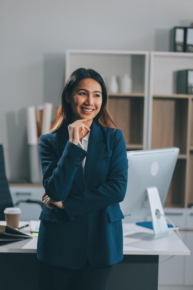 Portrait of Happy young Asian businesswoman looking at camera,arms crossed folded.Smiling woman executive manager,secretary offering professional business services standing in office. photo
