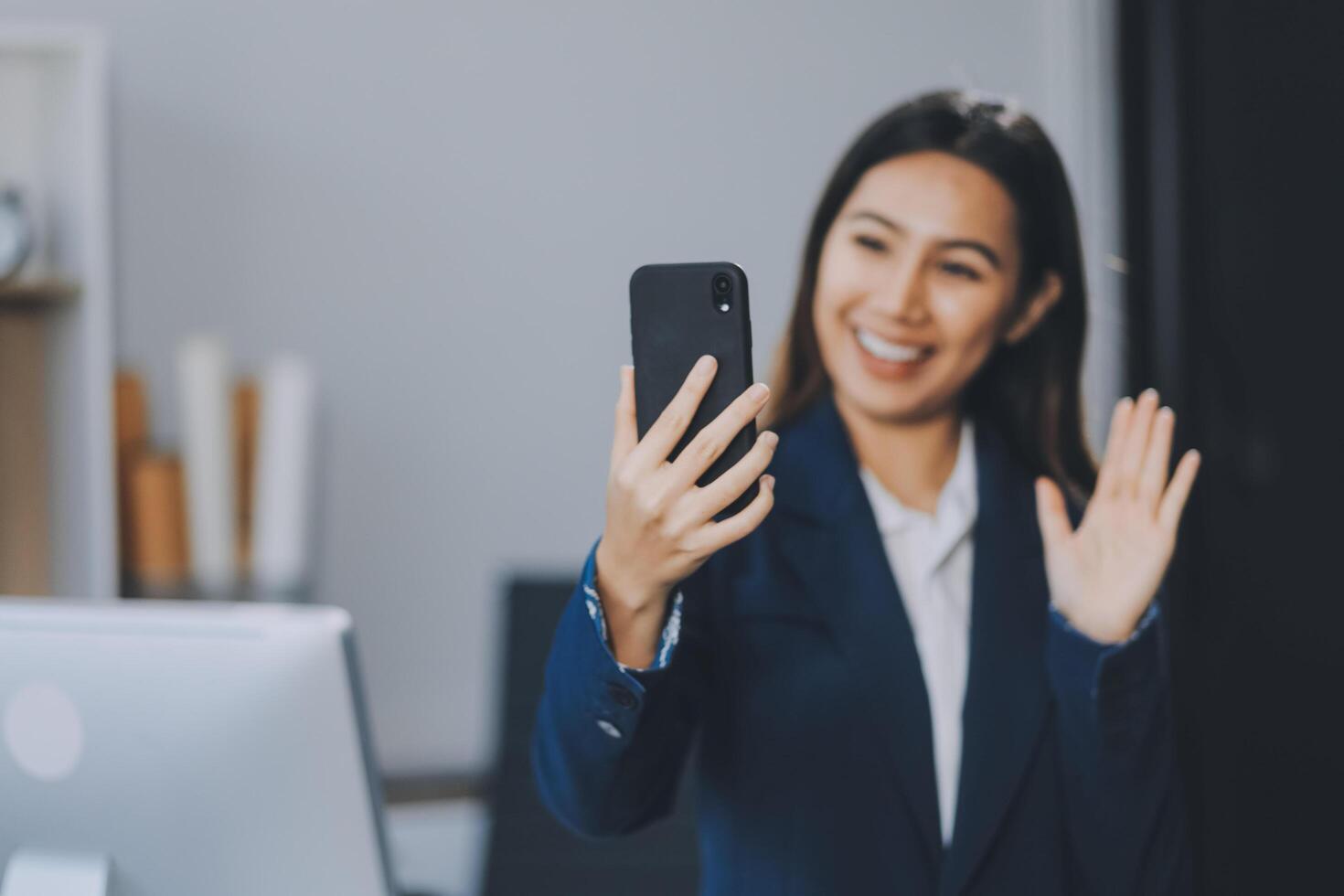 Young asian business woman in suit talking on smart phone isolated on white background, businesswoman speaking on smartphone with conversation, female holding cell phone, communication concept. photo