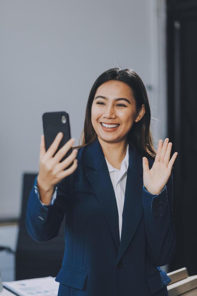 Young asian business woman in suit talking on smart phone isolated on white background, businesswoman speaking on smartphone with conversation, female holding cell phone, communication concept. photo