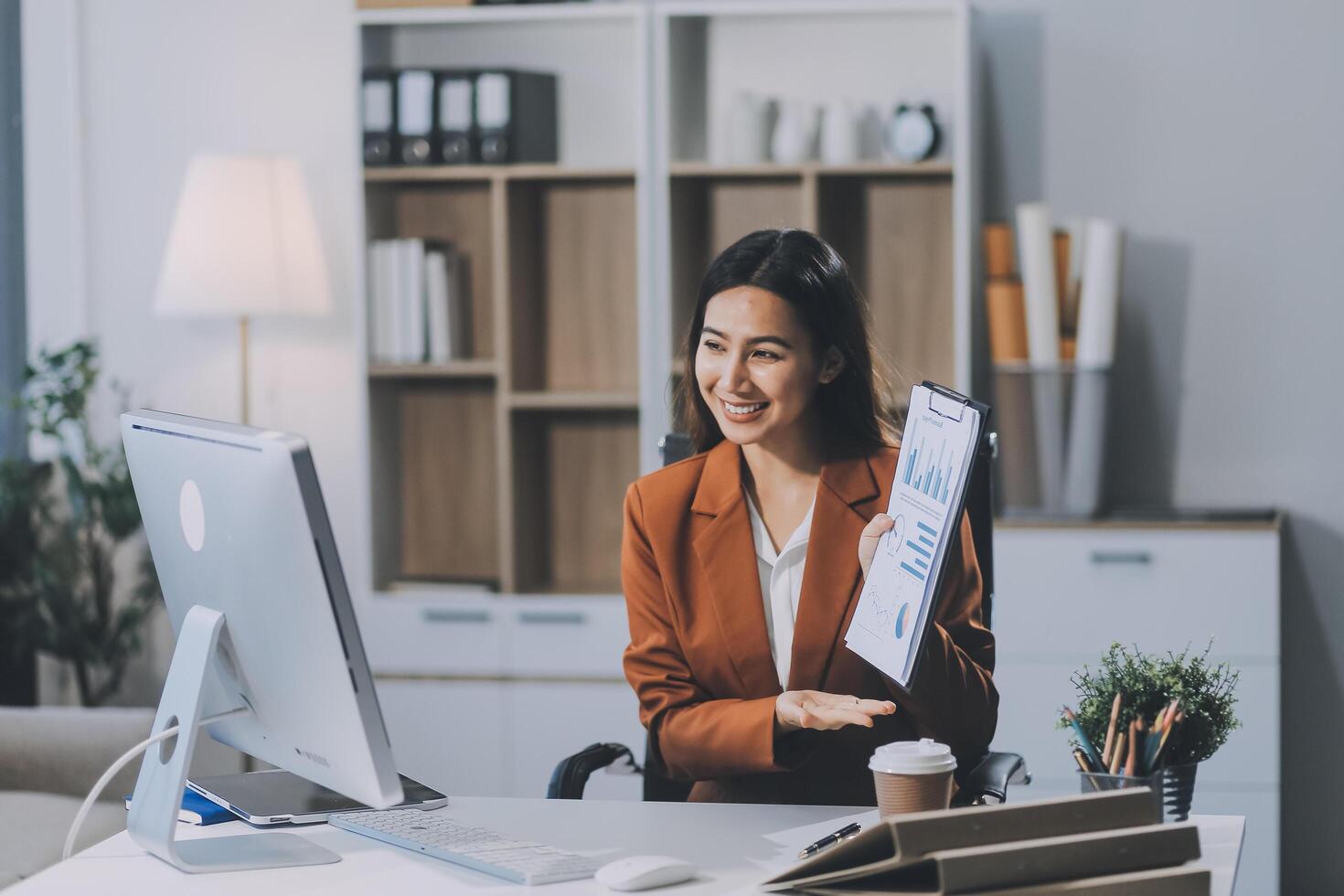 Business woman work process concept. Young woman working university project with generic design laptop. Happy excited woman at home workstation. Blurred background. photo