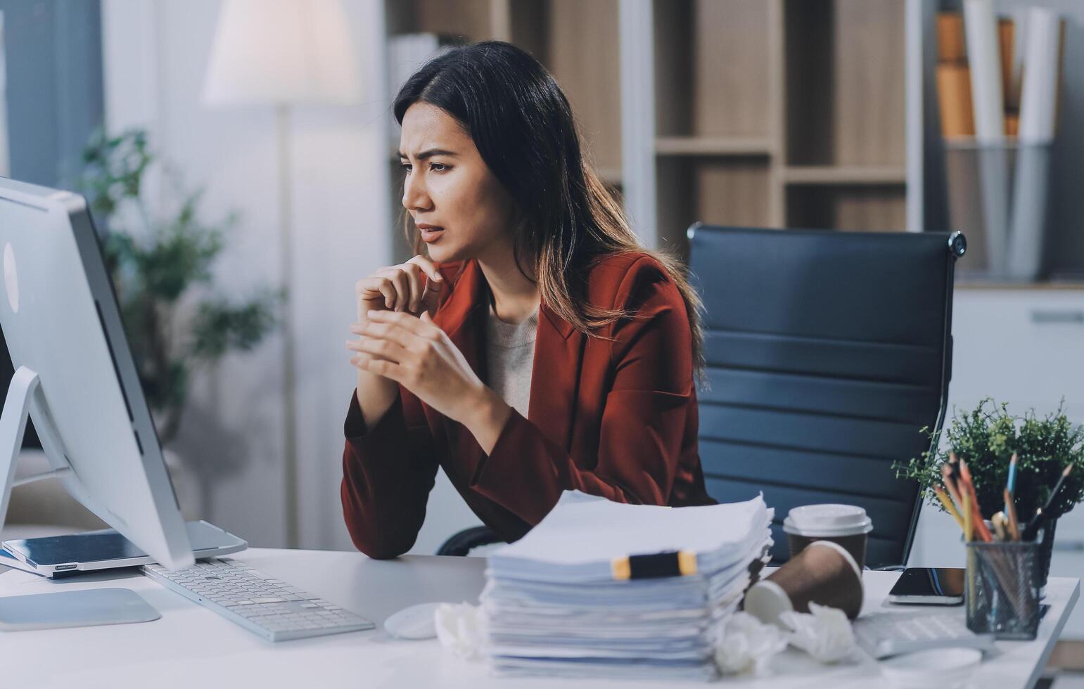 Young asian business woman with tired eyes and headache photo