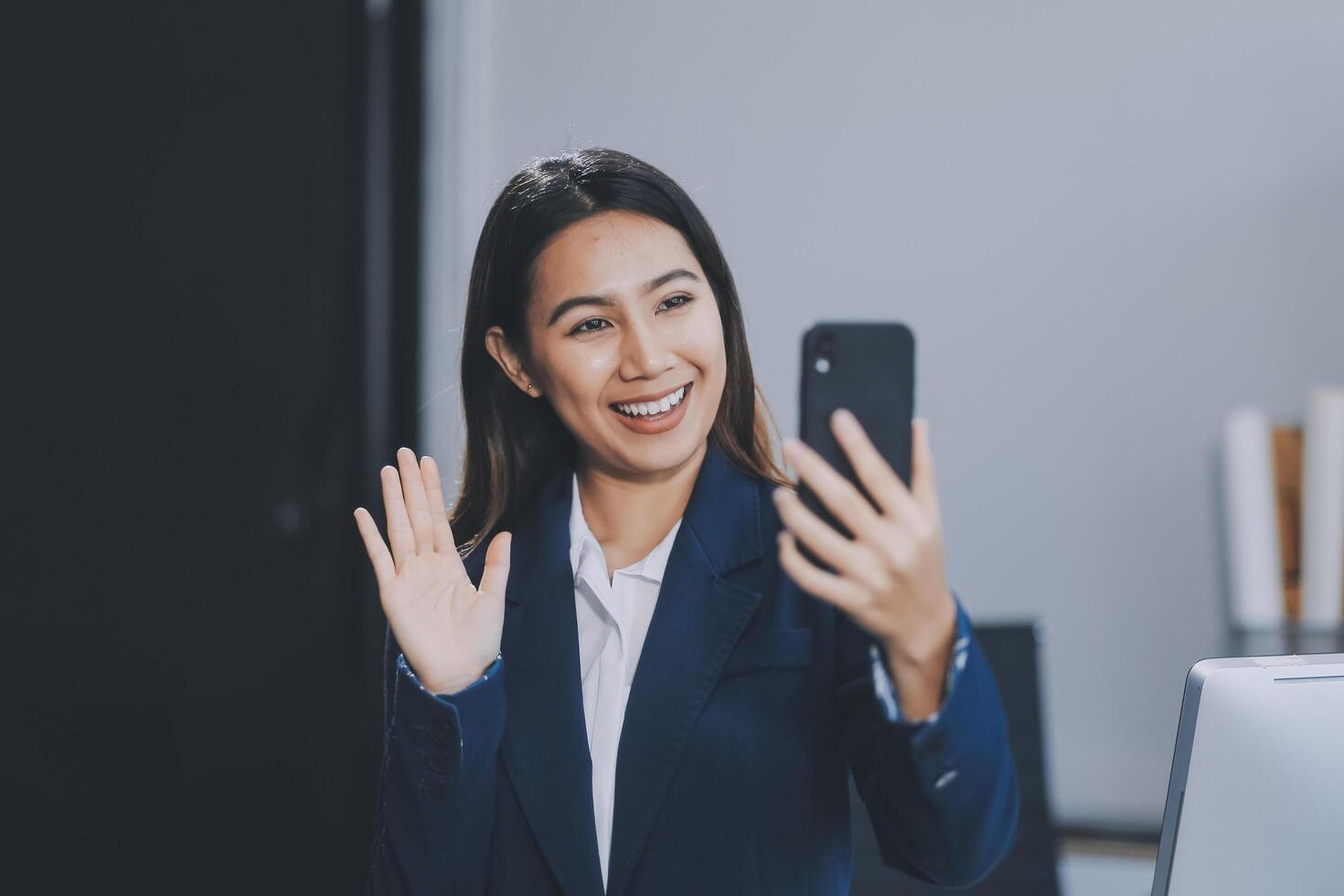 Young asian business woman in suit talking on smart phone isolated on white background, businesswoman speaking on smartphone with conversation, female holding cell phone, communication concept. photo