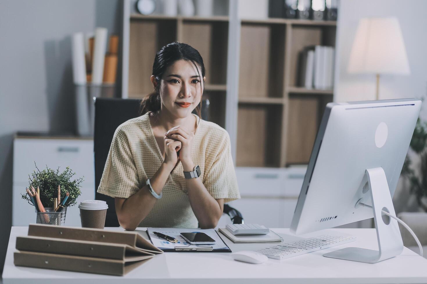 Young attractive businesswoman working on her project with laptop computer in modern office room. photo