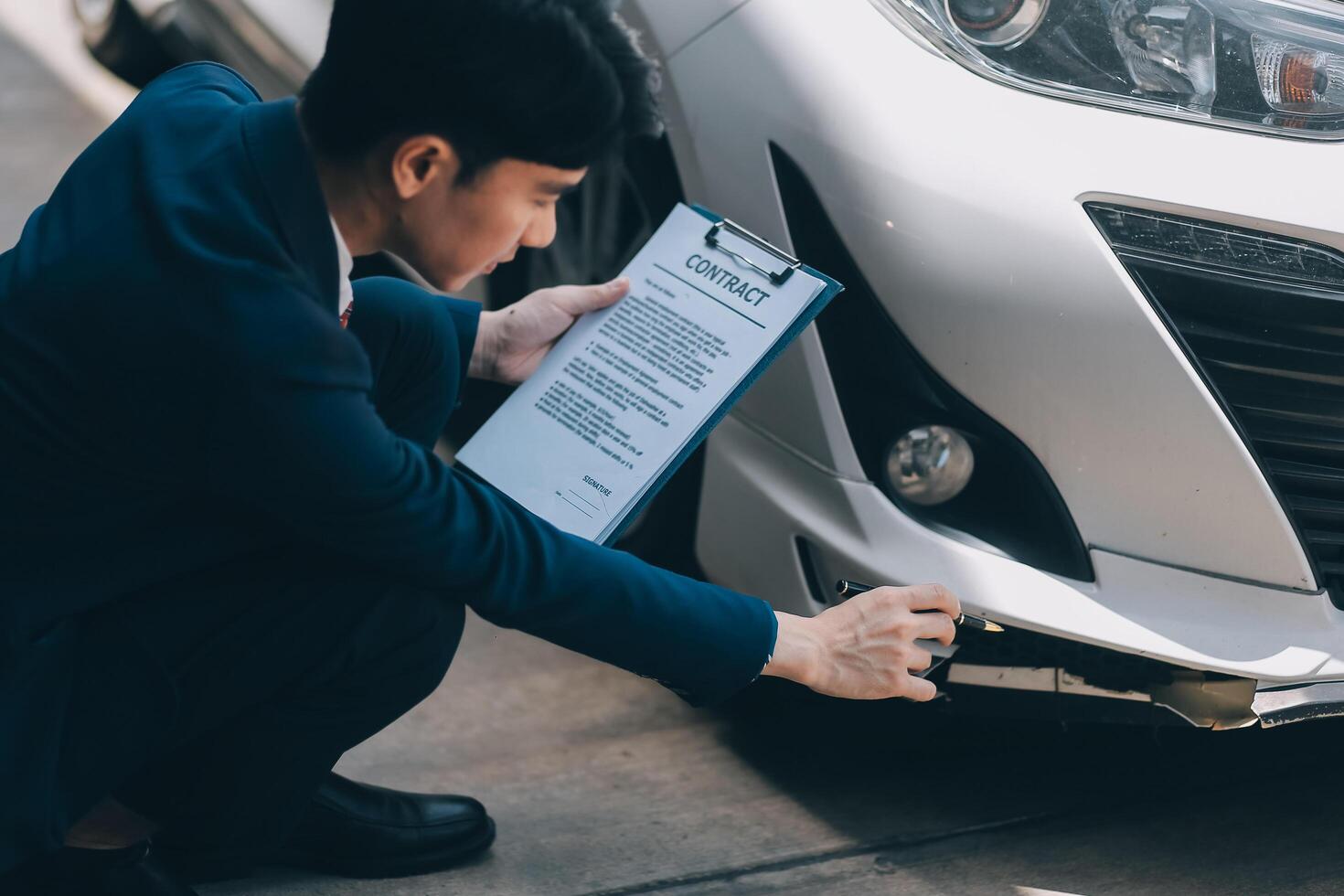 A young businesswoman is navigating car insurance options at her desk, considering premiums, deductibles, and coverage while understanding policies and managing claims efficiently. photo