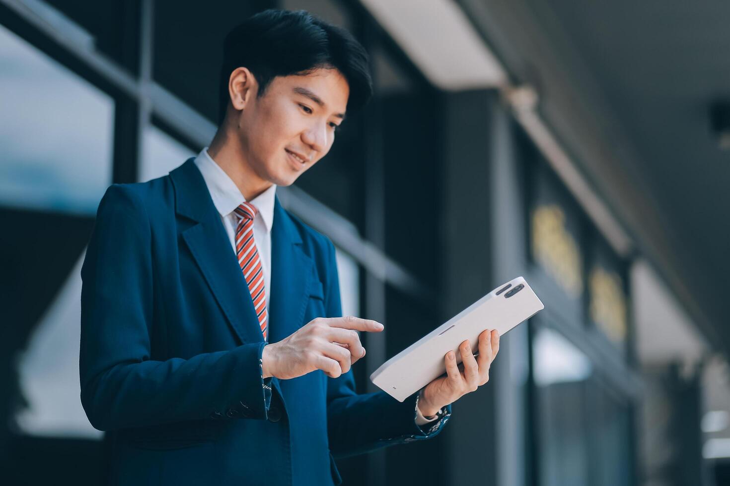 Businessman using tablet and enjoying in coffee break in front of the the corporation. Business, lifestyle concept photo