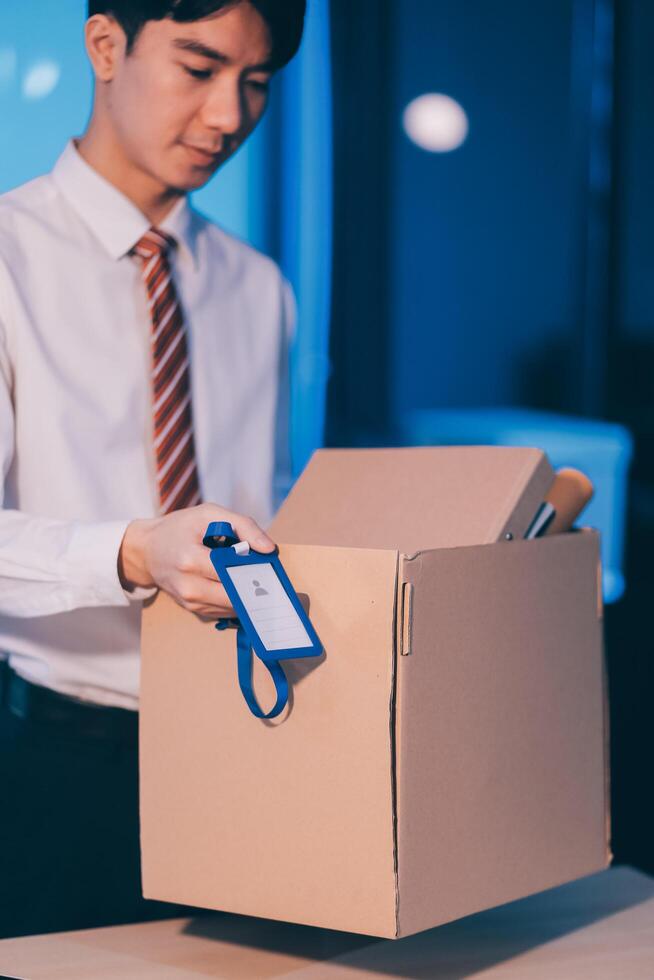 lose job, Your fired. Unhappy business man with surgical medical mask going out with cardboard, looking at camera and feeling looser. indoor shot. business, working and health care concept. photo