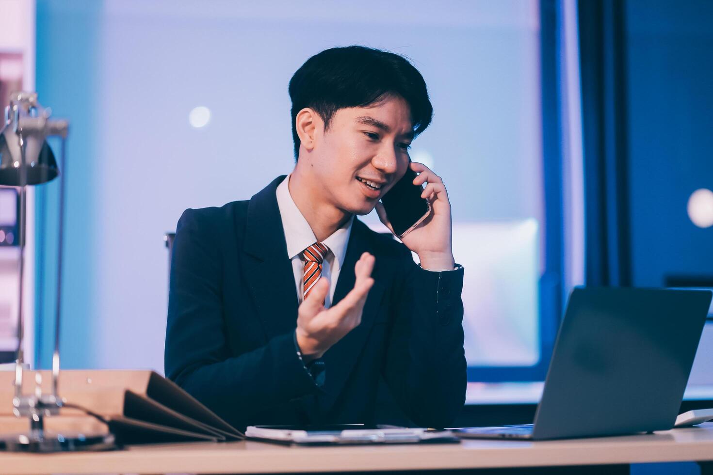 Serious trader using mobile phone app on smartphone for checking stock trading data analysis concept, focused businessman holding cellphone working in office with financial graph on computer monitors photo