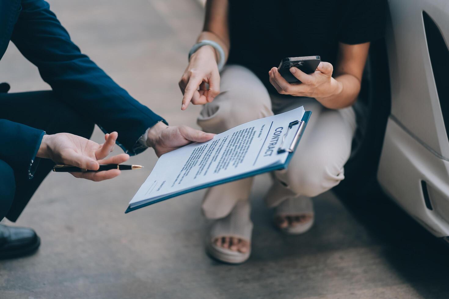 A young businesswoman is navigating car insurance options at her desk, considering premiums, deductibles, and coverage while understanding policies and managing claims efficiently. photo