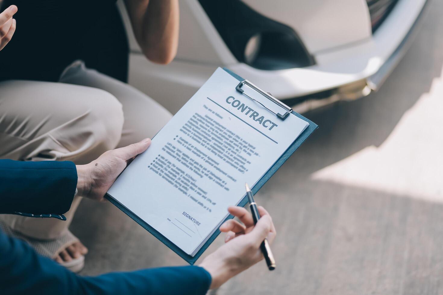 A young businesswoman is navigating car insurance options at her desk, considering premiums, deductibles, and coverage while understanding policies and managing claims efficiently. photo