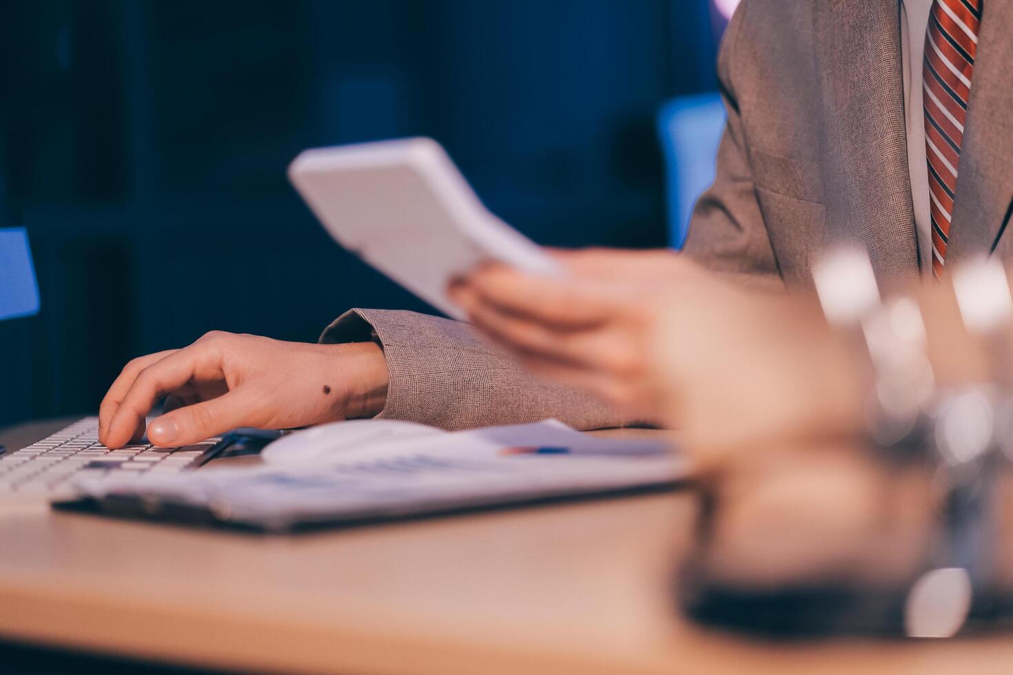 Business accounting concept Businessman uses calculator with laptop computer Budget and borrowed paper Calculate expenses, expenses, taxes online, manage company budgets, close-up images photo