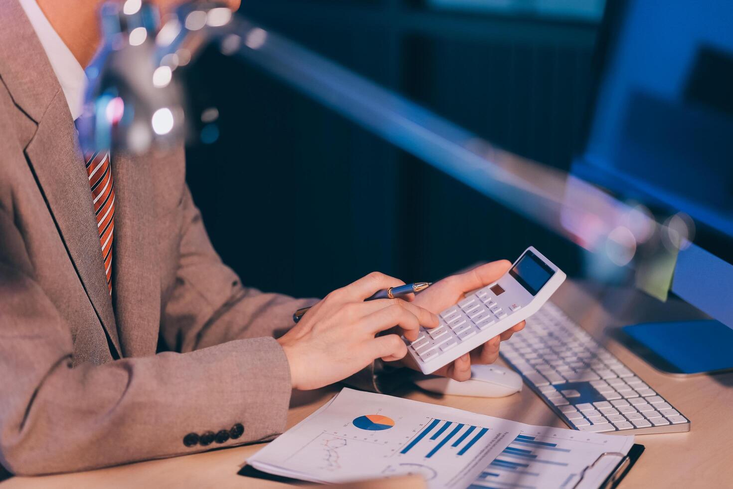 Business accounting concept Businessman uses calculator with laptop computer Budget and borrowed paper Calculate expenses, expenses, taxes online, manage company budgets, close-up images photo