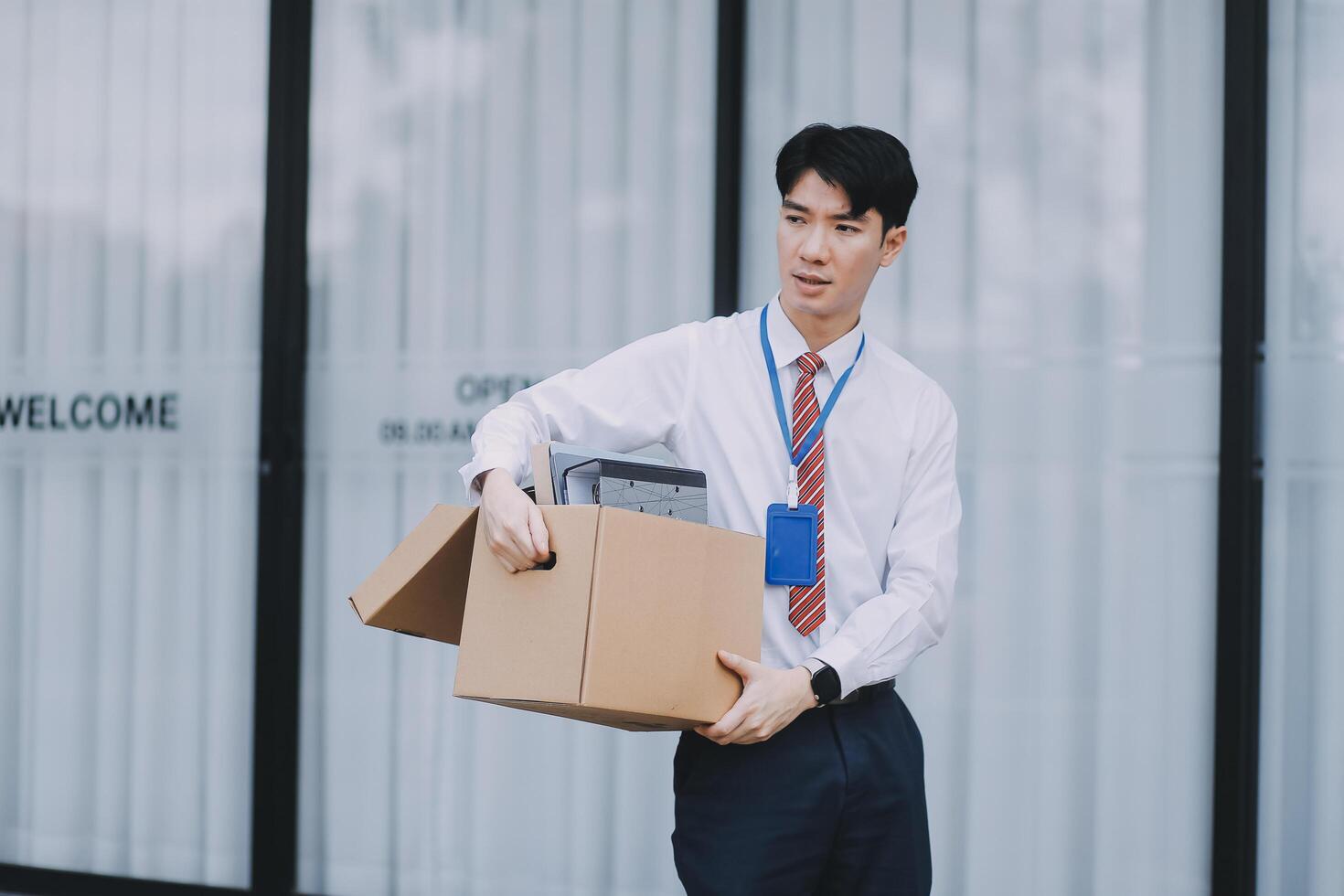 Sadness depressed Businessman with box cardboard packing personal items after losing jobs. Failure businessman sitting at stair front of building. Your fired Unemployed Jobless People Crisis photo