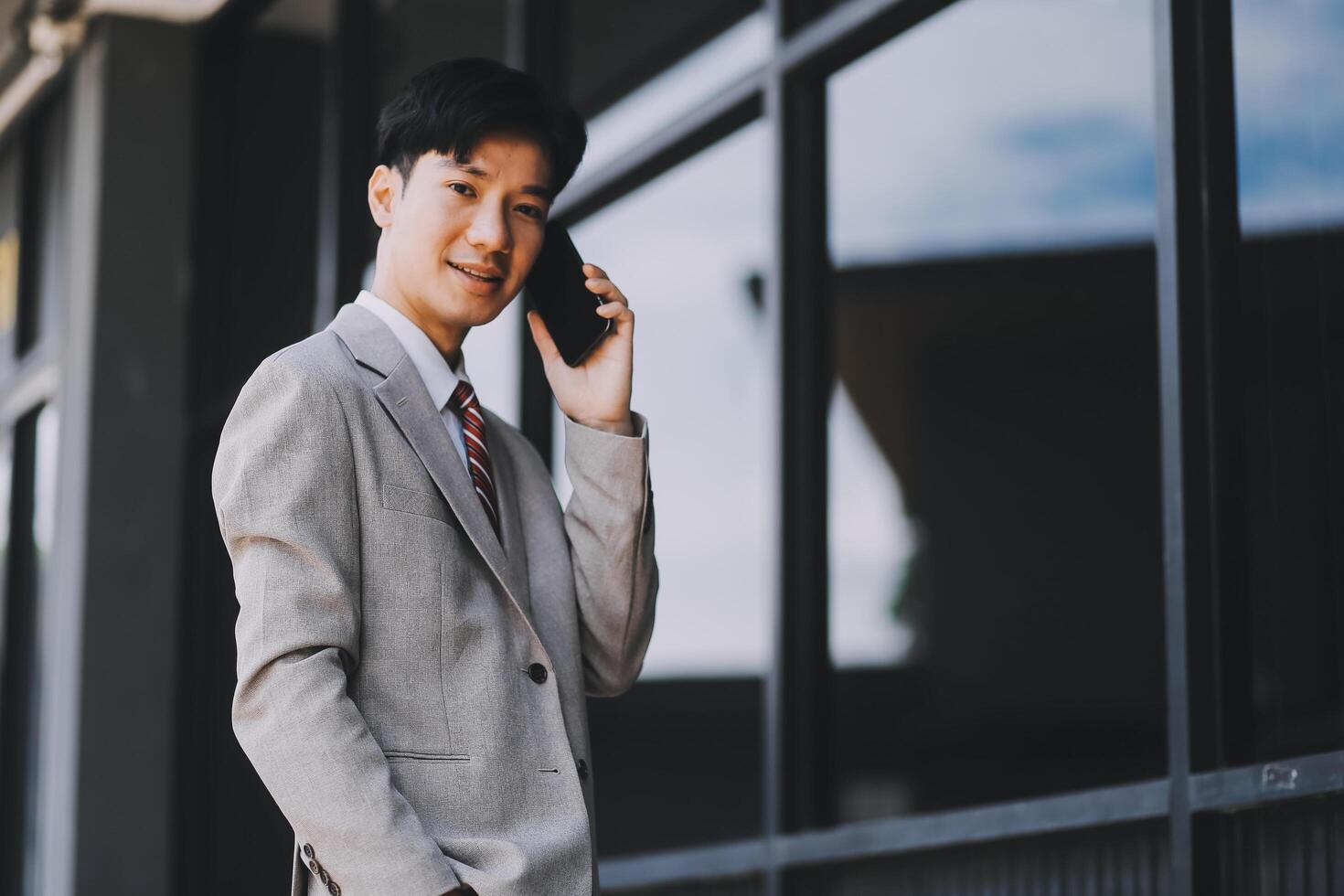 Good news about project. Young businessman talking with client via mobile phone and checking money transfer on tablet. Business, education, lifestyle concept photo