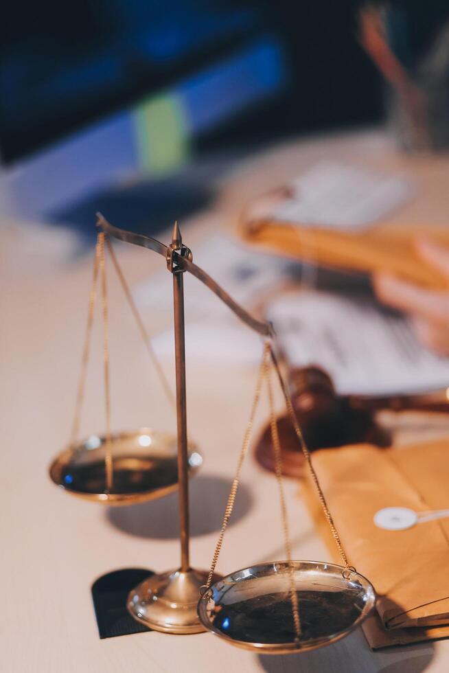 Judge gavel with Justice lawyers having team meeting at law firm background. Concepts of Law and Legal services. photo