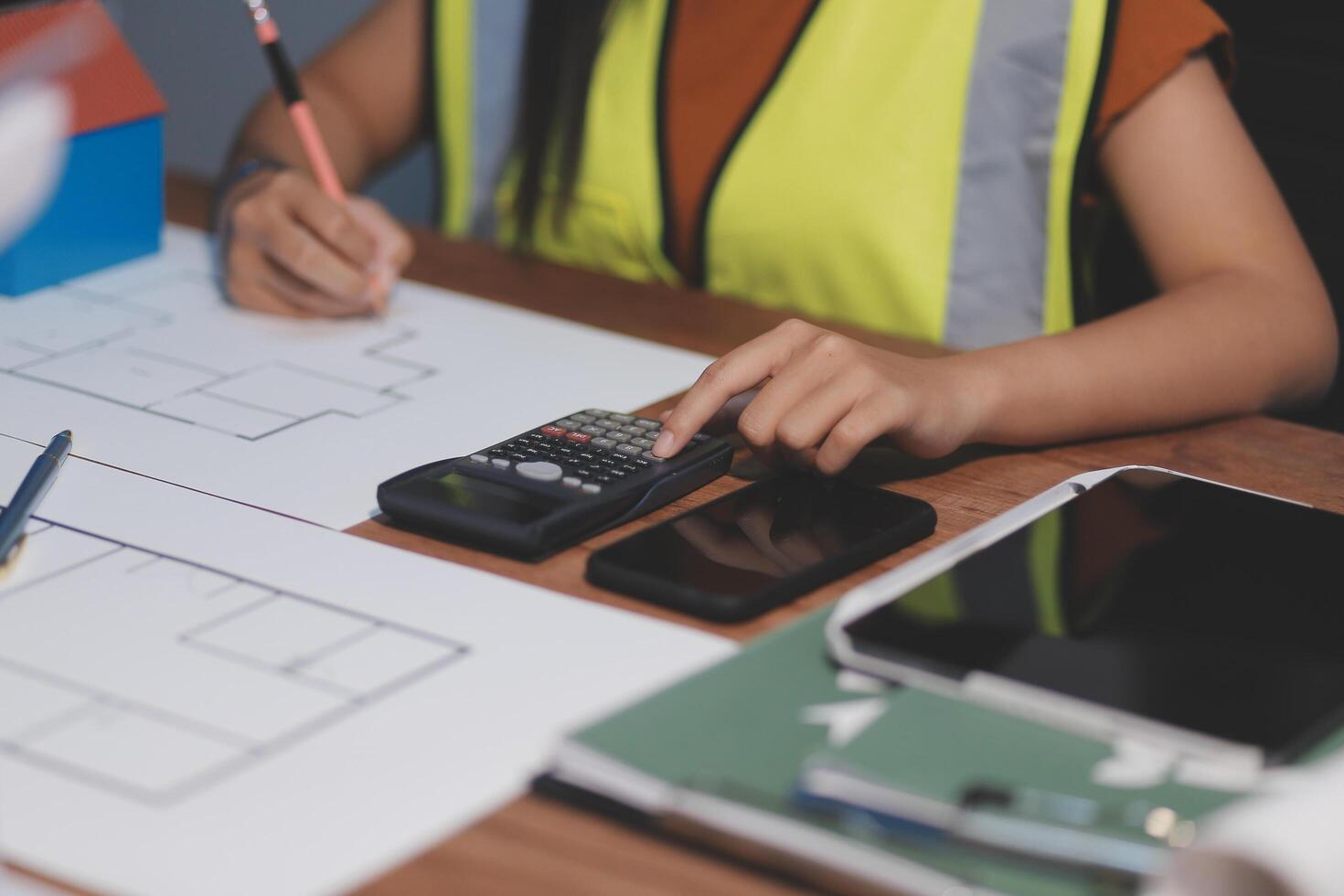 Female architect working at home She looked at the blueprint. photo