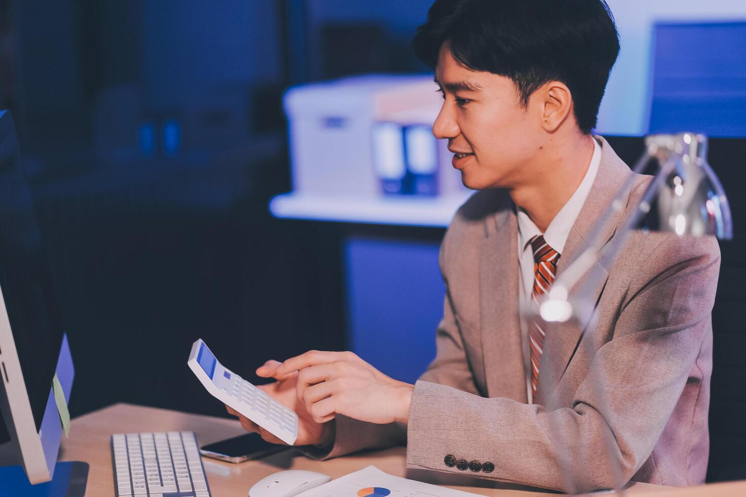 Business accounting concept Businessman uses calculator with laptop computer Budget and borrowed paper Calculate expenses, expenses, taxes online, manage company budgets, close-up images photo