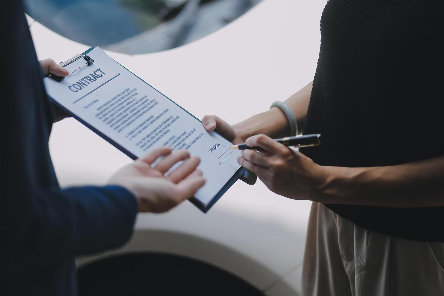 A young businesswoman is navigating car insurance options at her desk, considering premiums, deductibles, and coverage while understanding policies and managing claims efficiently. photo