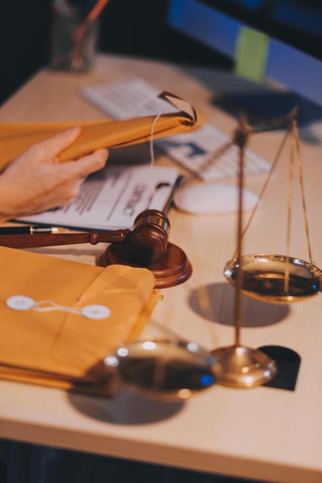 Judge gavel with Justice lawyers having team meeting at law firm background. Concepts of Law and Legal services. photo