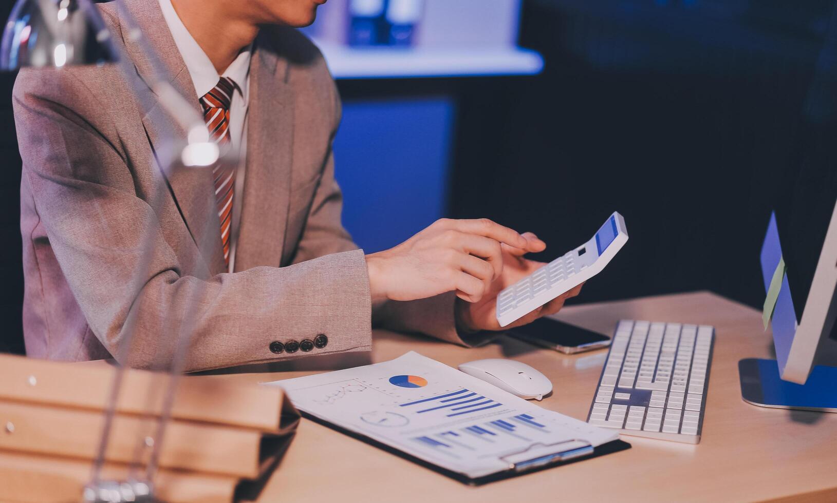 Business accounting concept Businessman uses calculator with laptop computer Budget and borrowed paper Calculate expenses, expenses, taxes online, manage company budgets, close-up images photo