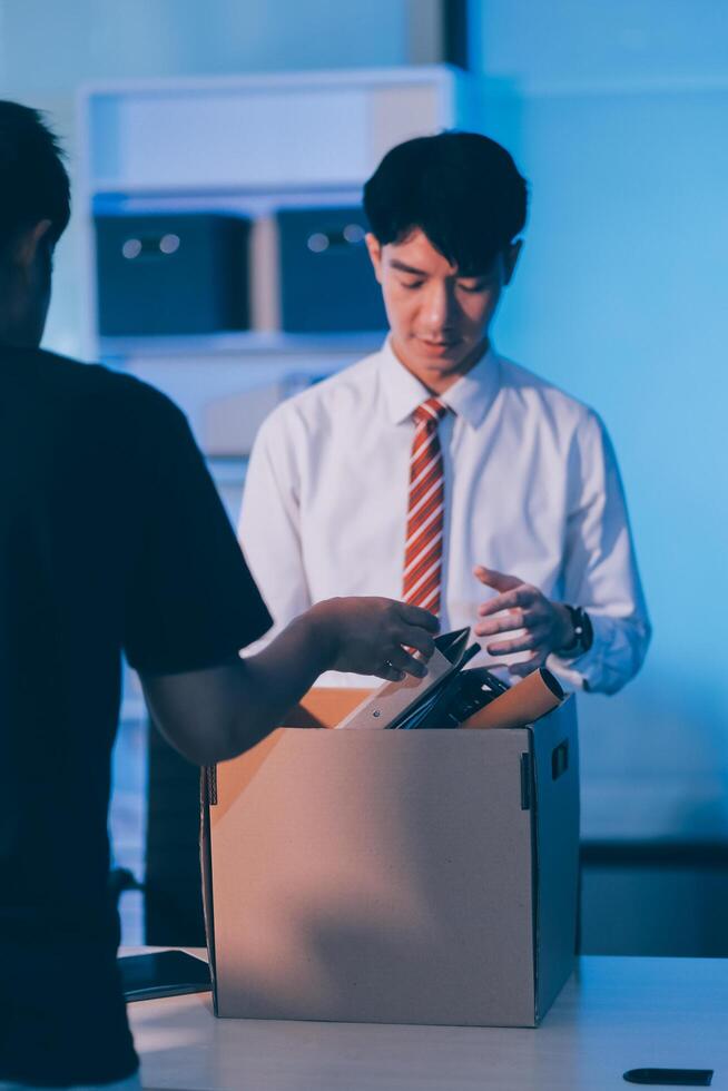 lose job, Your fired. Unhappy business man with surgical medical mask going out with cardboard, looking at camera and feeling looser. indoor shot. business, working and health care concept. photo