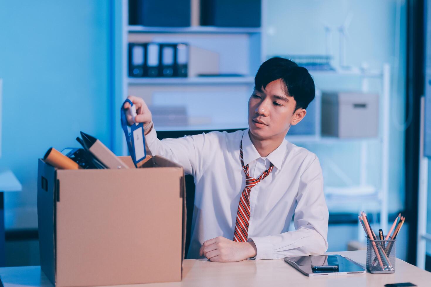 lose job, Your fired. Unhappy business man with surgical medical mask going out with cardboard, looking at camera and feeling looser. indoor shot. business, working and health care concept. photo
