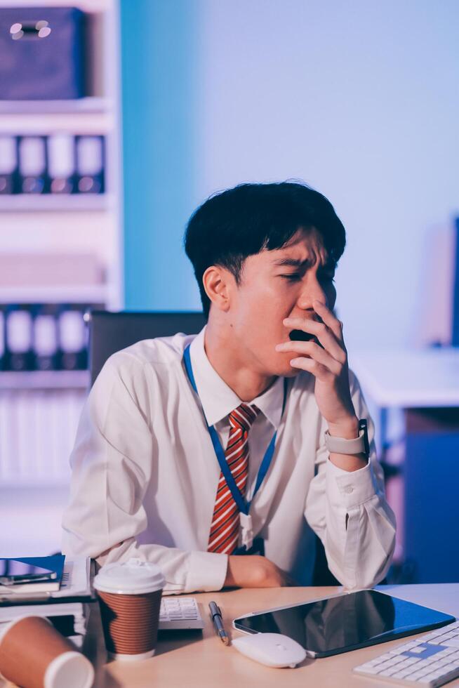Businessman workaholic sit at the computer working late at night yawn tired and sleeping in the office,Hard work in the later time concept photo