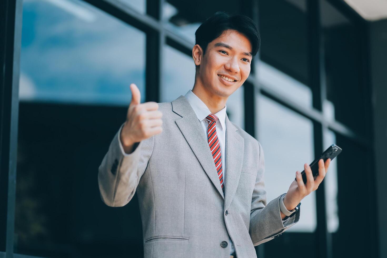 Good news about project. Young businessman talking with client via mobile phone and checking money transfer on tablet. Business, education, lifestyle concept photo