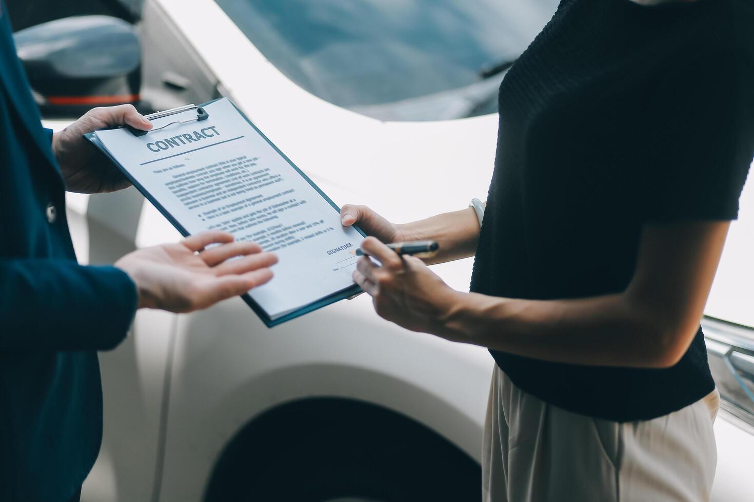 A young businesswoman is navigating car insurance options at her desk, considering premiums, deductibles, and coverage while understanding policies and managing claims efficiently. photo