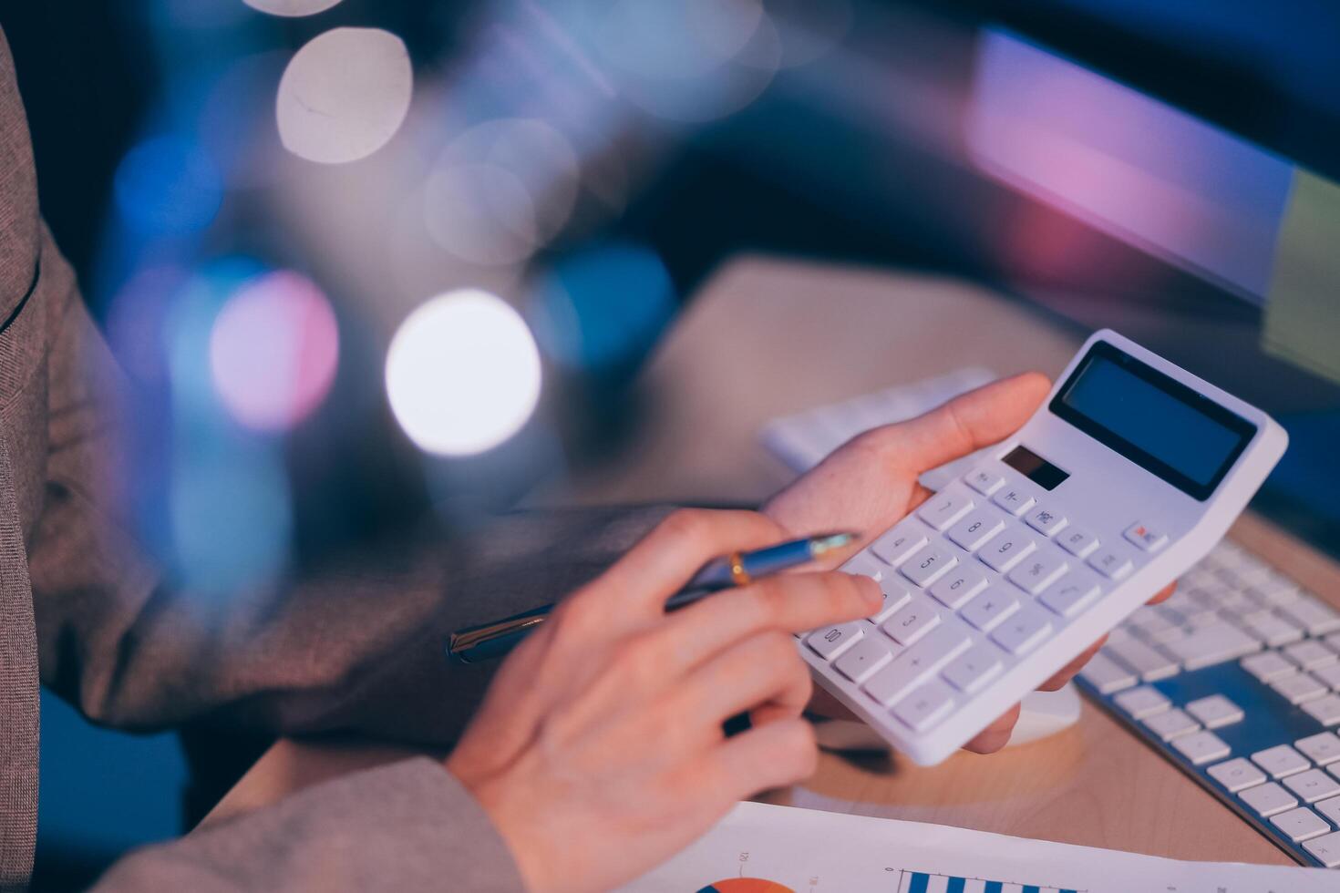 Business accounting concept Businessman uses calculator with laptop computer Budget and borrowed paper Calculate expenses, expenses, taxes online, manage company budgets, close-up images photo