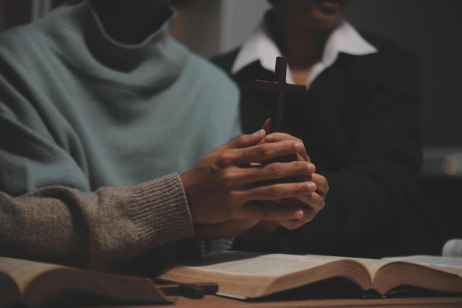 Christian group are praying to god with the bible and sharing the gospel. Concept of faith for god. photo