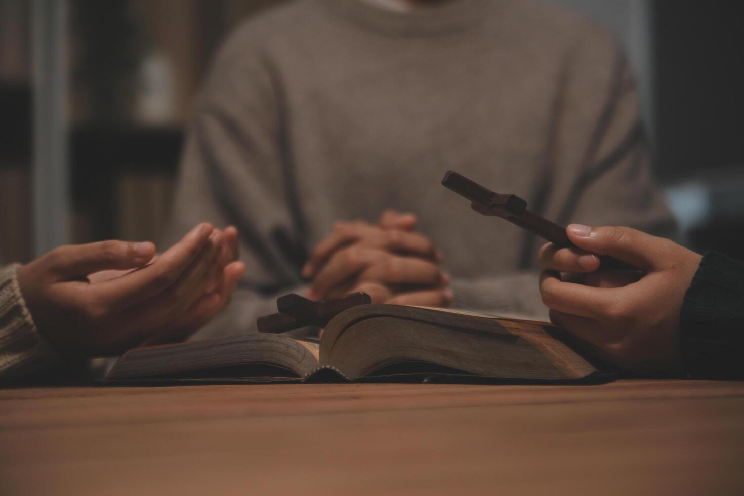 Christian group are praying to god with the bible and sharing the gospel. Concept of faith for god. photo