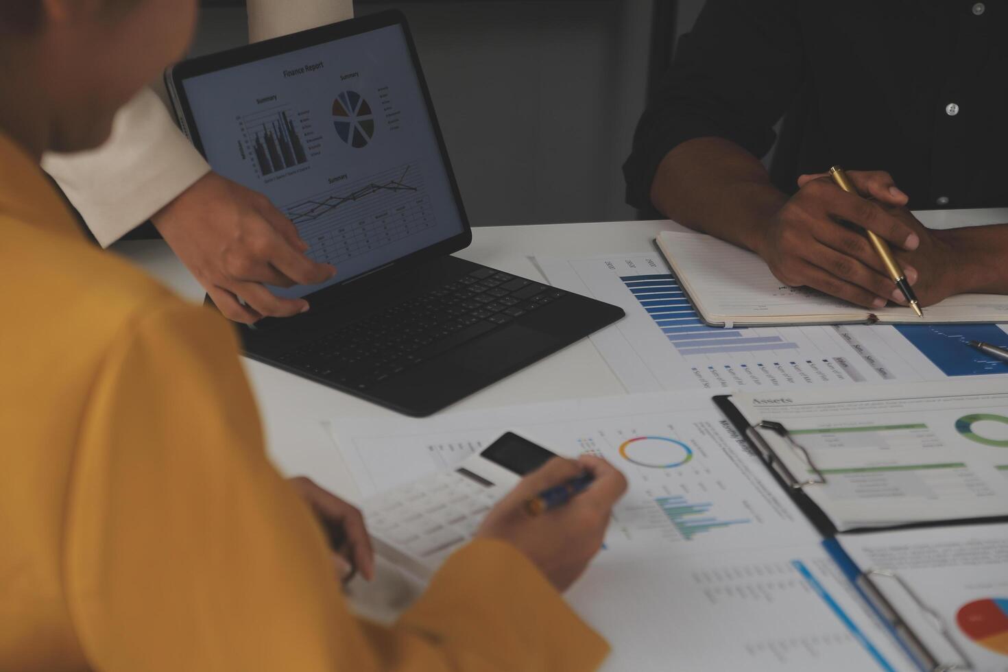 Close up of Business team analyzing income charts and graphs with modern laptop computer. Business analysis and strategy concept. photo