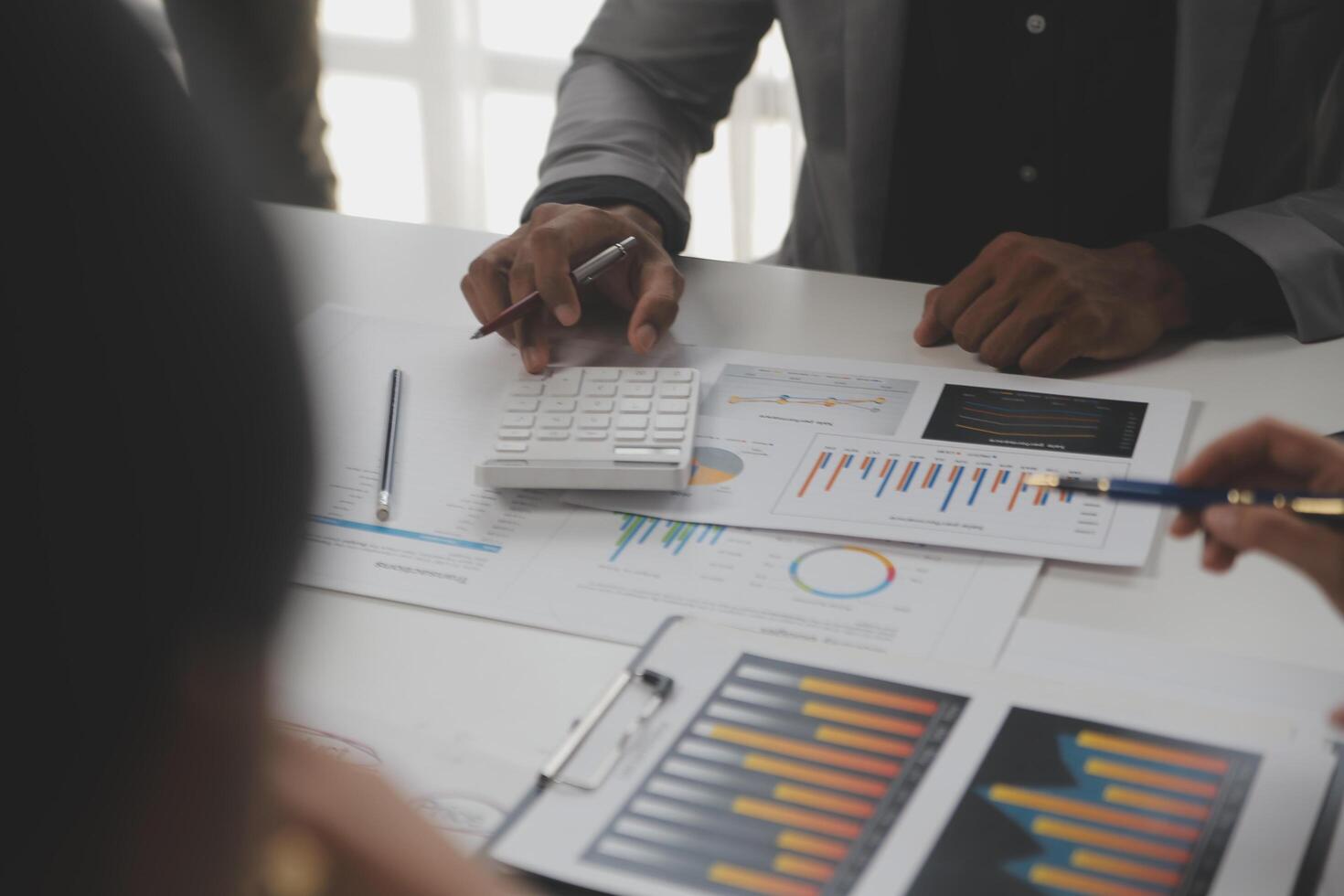 Close up of Business team analyzing income charts and graphs with modern laptop computer. Business analysis and strategy concept. photo