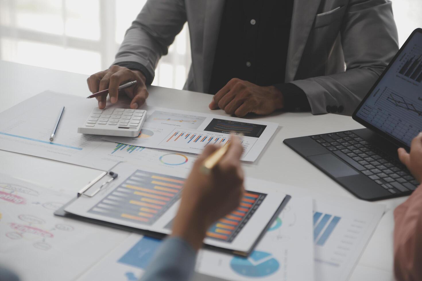Close up of Business team analyzing income charts and graphs with modern laptop computer. Business analysis and strategy concept. photo
