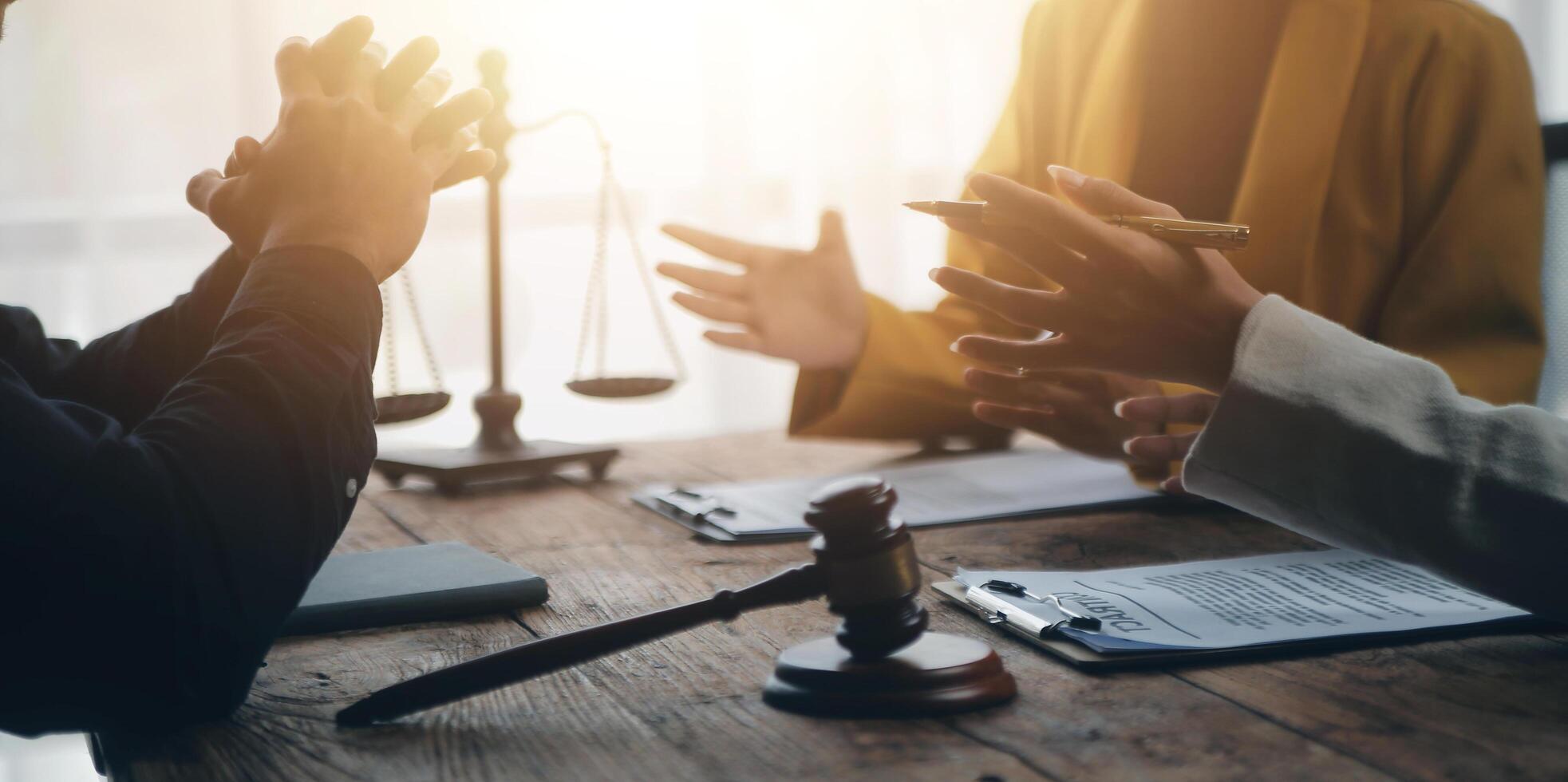 Business and lawyers discussing contract papers with brass scale on desk in office. Law, legal services, advice, justice and law concept picture with film grain effect photo