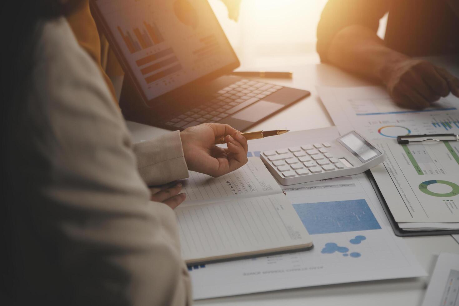 Close up of Business team analyzing income charts and graphs with modern laptop computer. Business analysis and strategy concept. photo